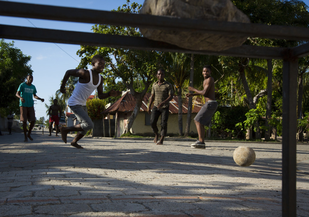 Kids gather on a Sunday morning in the streets of Coteaux, Haiti, for a game of soccer. (Photo By: Garrett Hubbard)