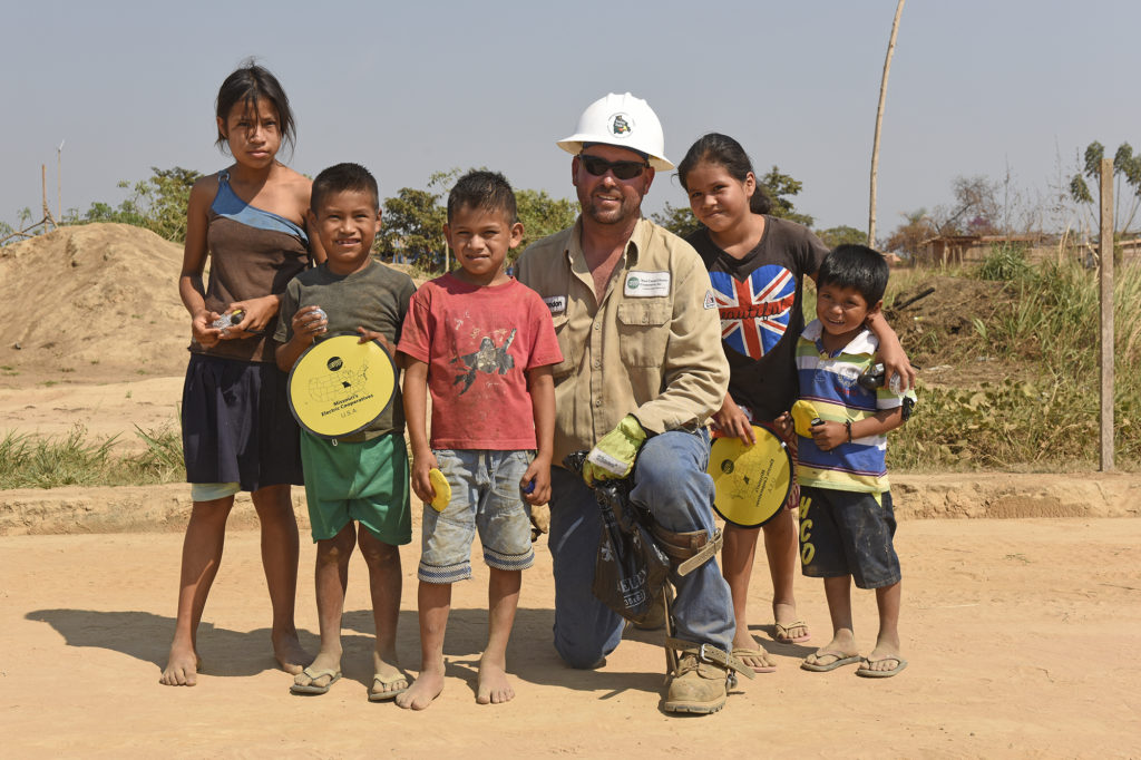 Brandon Steffen poses with children in the village of Dos de Junio, Bolivia. (Photo by Jim McCarty)