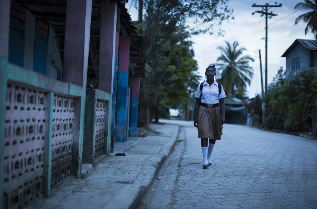 Ruth, 14, one of four girls in her home, begins her 45-minute walk to school. (Photo By: Garrett Hubbard)