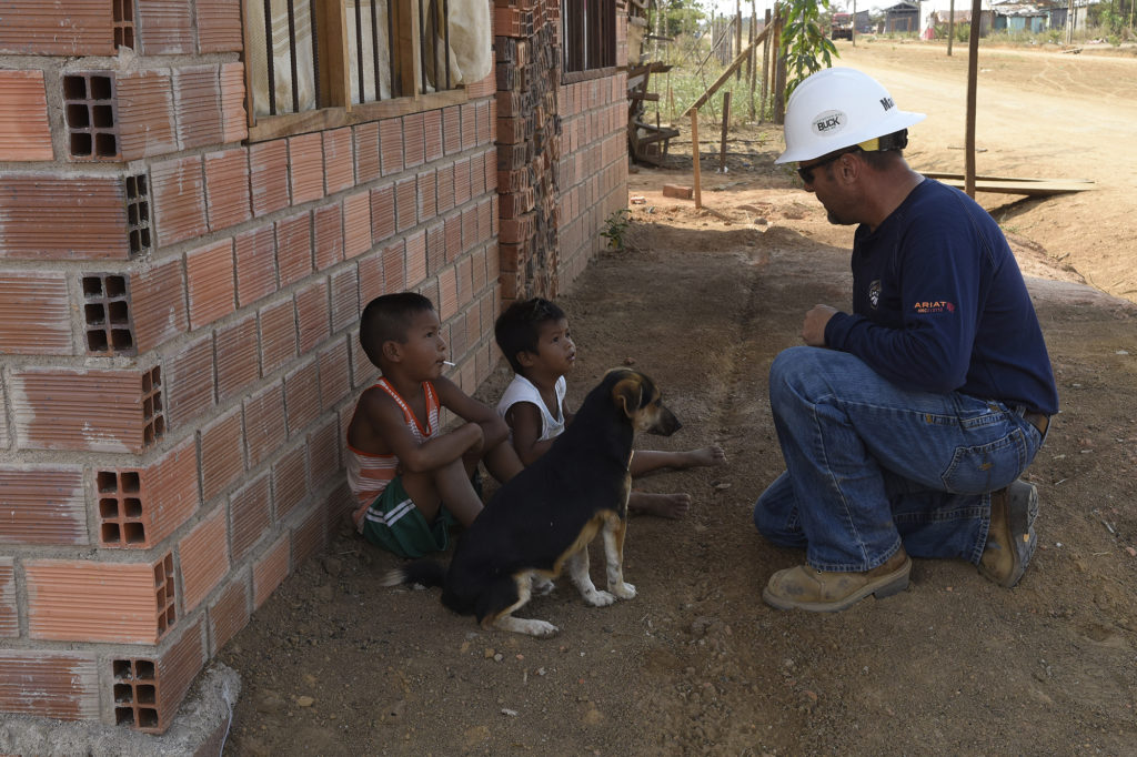 Heath Martin speaks with two children and their dog in the village of Dos de Junio, Bolivia. (Photo courtesy Noah F. Rudovsky)