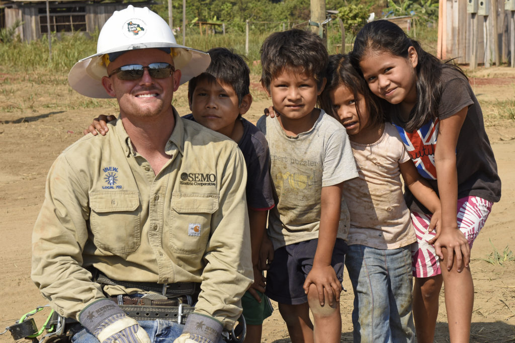 Jared Kelley from SEMO Electric Cooperative and children from Dos de Junio, Bolivia. (Photo by Jim McCarty)