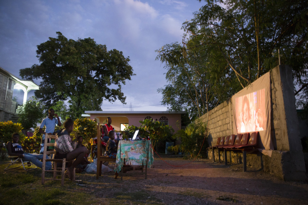 There’s no stadium seating, but movie night in Haiti is something youngsters look forward to. (Photo By: Garrett Hubbard)