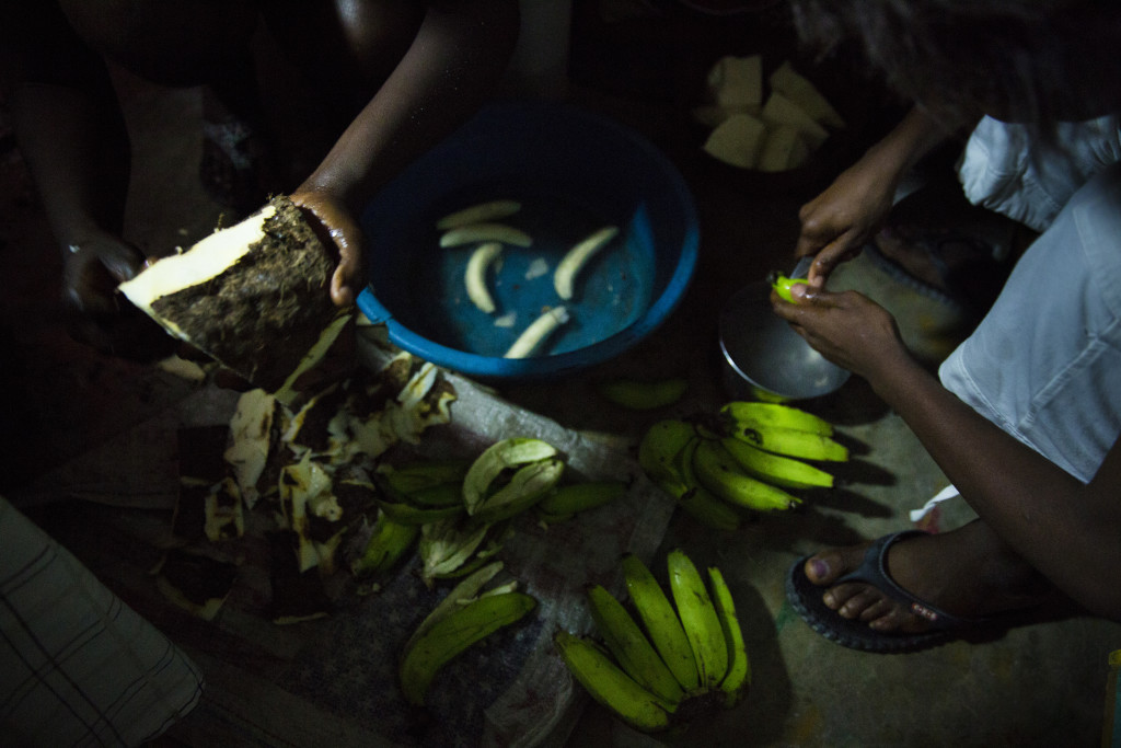 Family members at a home in Roche-a-Bateau, Haitai, wake up at 4 a.m. to do household chores such as preparing and cooking meals, ironing clothes, and sweeping. (Photo By: Garrett Hubbard)