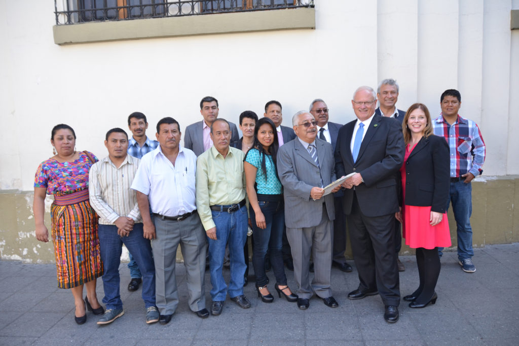 NRECA President Mel Coleman receives the registration of the new Guatemalan electric co-ops from Rodolfo Orozco, executive director of CONFECOOP. (Photo By: Rob Roedel)