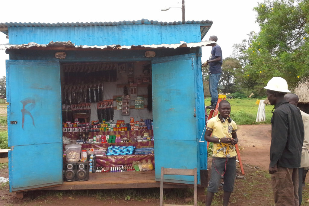 Linemen in South Sudan bring electricity to a small sundry shop in the town of Yei. - Power development Africa (Photo courtesy NRECA International)