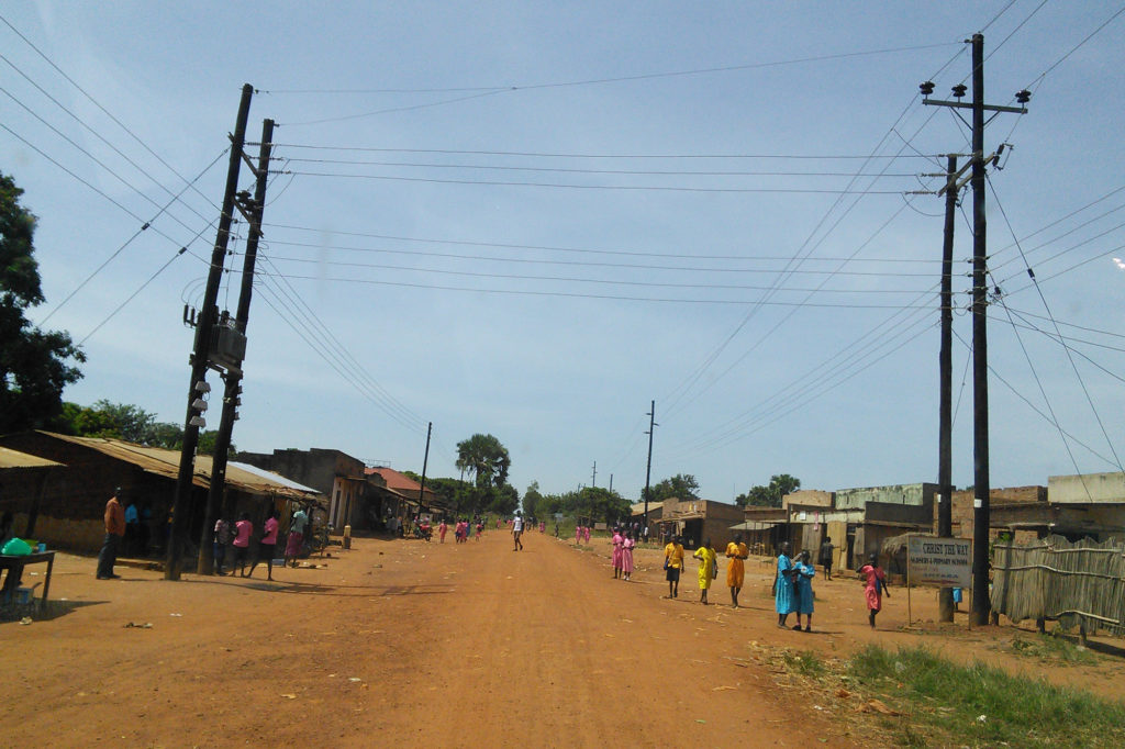 Electric lines stretch across a village road in Uganda. (Photo courtesy NRECA International)